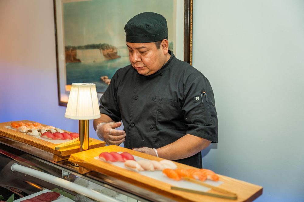 Chef plating sushi at a private event