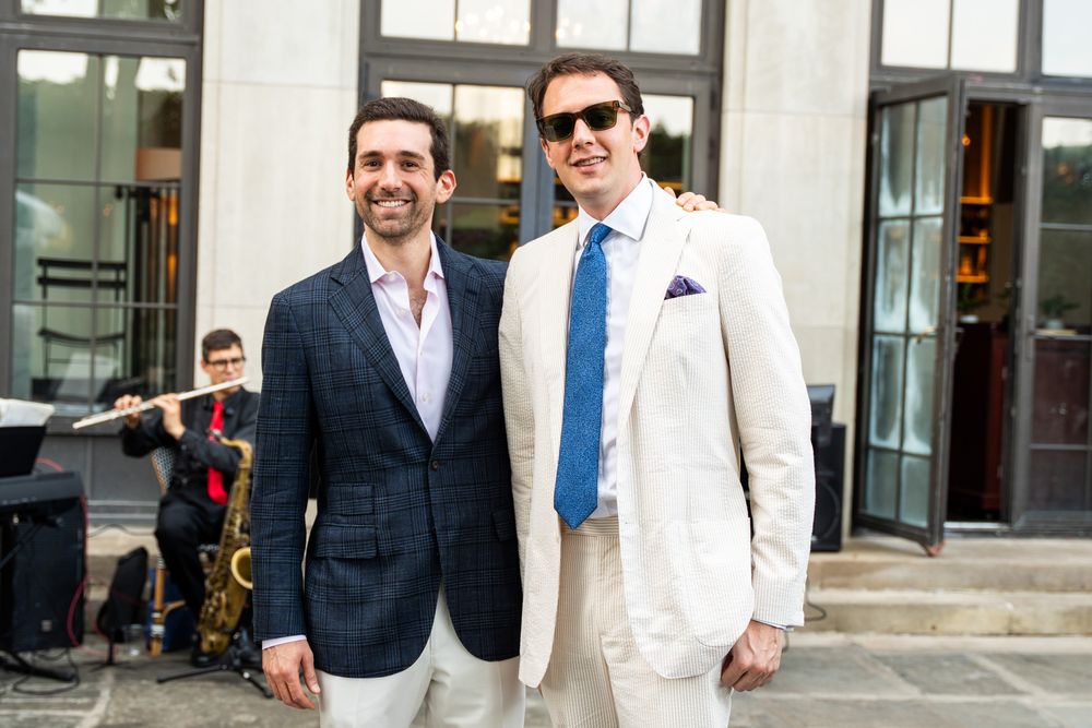 Two guests in suits arriving at a River Club event